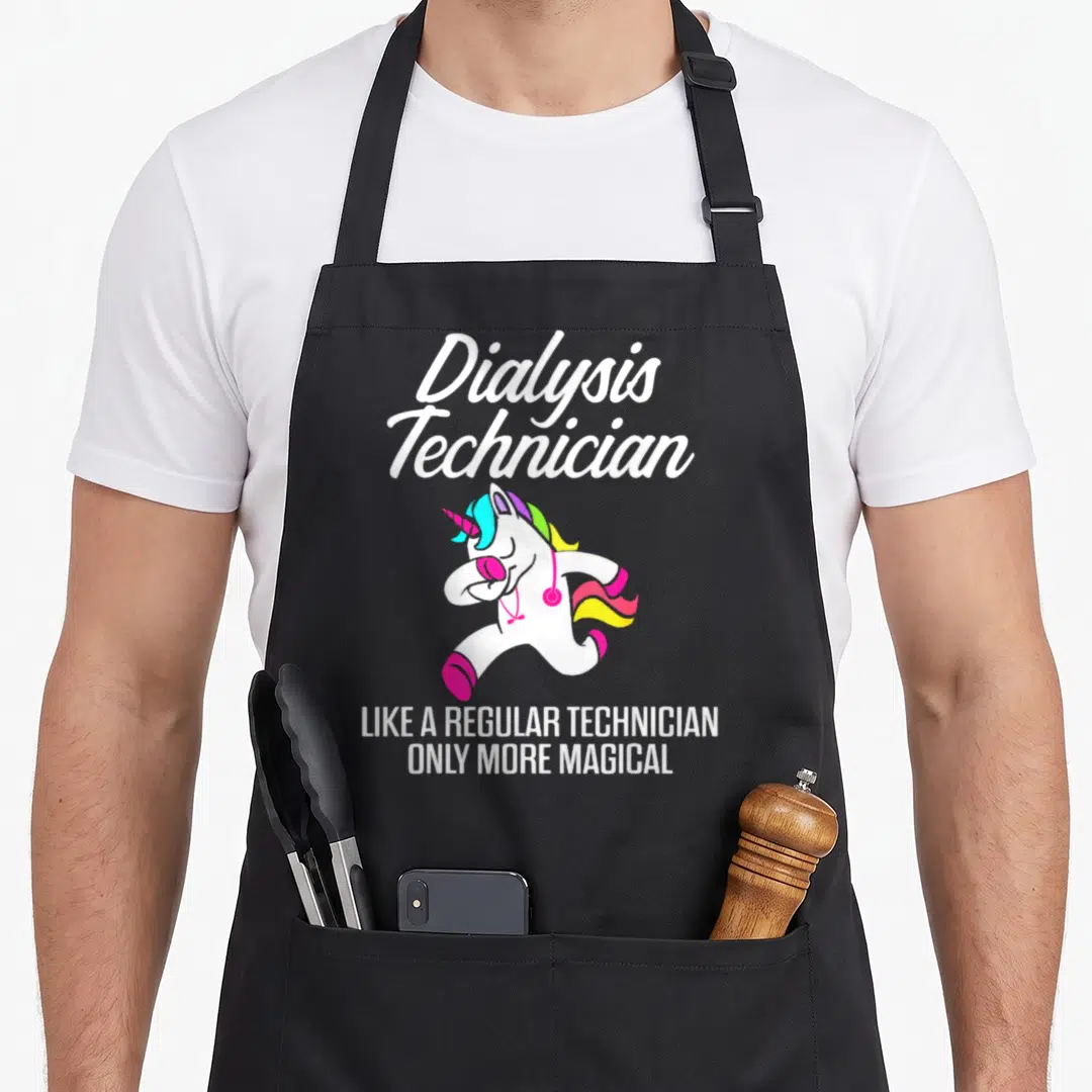 Dialysis administrative vibes apron - Cartoon unicorn with pink stethoscope and rainbow mane under Dialysis Technician — shown on a black cotton canvas apron against a white background