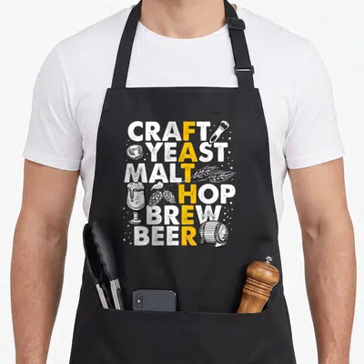 Father beer brewing apron - FATHER vertical pun in CRAFT YEAST MALT HOP BREW BEER with brewery icons — shown on a black cotton canvas apron against a white background