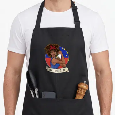 Haiti haitian boy apron - Cartoon woman flexing arm in front of blue red circle with yellow stars and HAITIAN GIRL — shown on a black cotton canvas apron against a white background