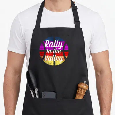 Phoenix rally apron - Striped basketball with Rally In the Valley text in distressed white font — shown on a black cotton canvas apron against a white background