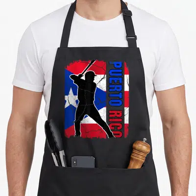 Rican baseball apron - Black batter silhouette over distressed red white and blue flag with vertical Puerto Rico text — shown on a black cotton canvas apron against a white background
