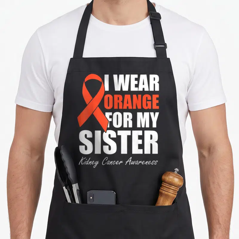 Sister i love cranberries apron - Orange awareness ribbon next to stacked I WEAR ORANGE FOR MY SISTER text — shown on a black cotton canvas apron against a white background