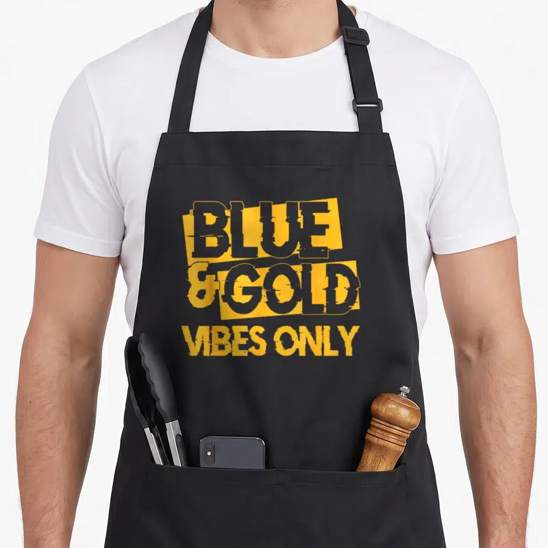 Blue game football apron - Stacked yellow and grey typography reading Blue and Gold Vibes Only on dark background — shown on a black cotton canvas apron against a white background