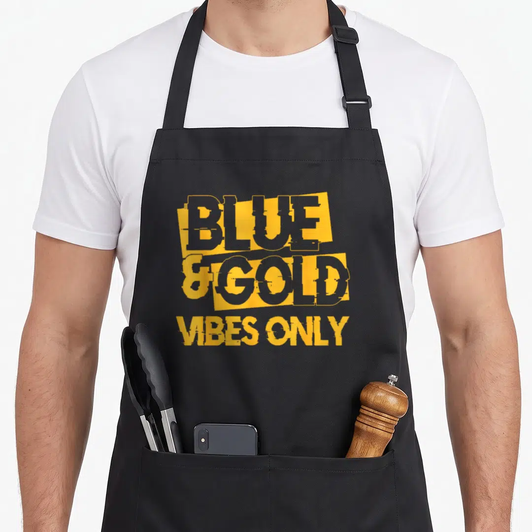 Blue game football apron - Stacked yellow and grey typography reading Blue and Gold Vibes Only on dark background — shown on a black cotton canvas apron against a white background