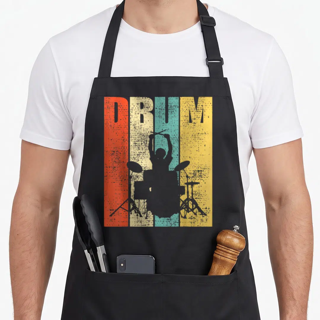 Drummer pigeon forge apron - Grey drummer silhouette over red beige teal and yellow stripes with DRUM text — shown on a black cotton canvas apron against a white background