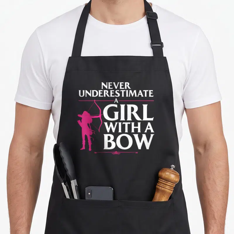 Archery shooting apron - Pink girl archer silhouette beside white stacked text Never Underestimate A Girl With A Bow — shown on a black cotton canvas apron against a white background