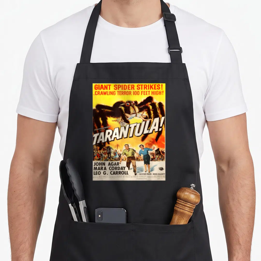 Spider movie poster apron - Vintage Tarantula movie poster print with giant spider and cast names on yellow background — shown on a black cotton canvas apron against a white background