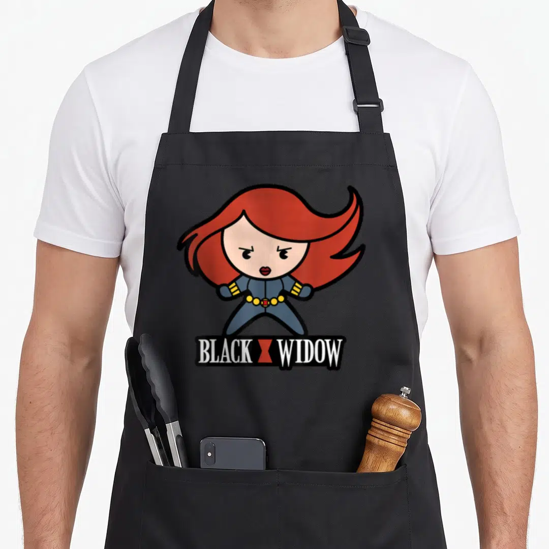 Stance kawaii apron - Chibi character with red hair blue suit and BLACK X WIDOW banner text — shown on a black cotton canvas apron against a white background
