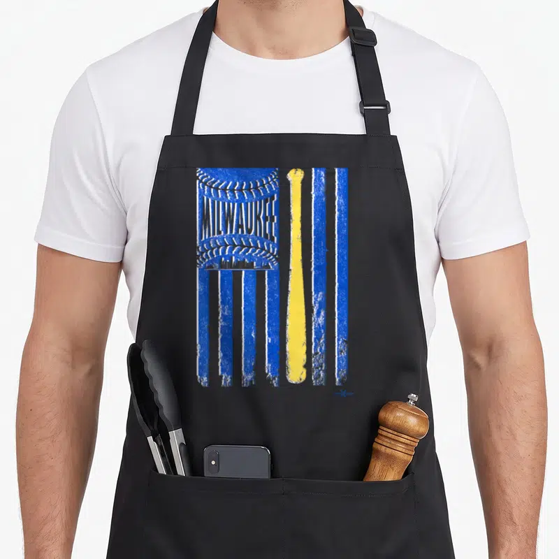 Flag milwaukee apron - MILWAUKEE text on baseball with yellow bat and blue stripes — shown on a black cotton canvas apron against a white background