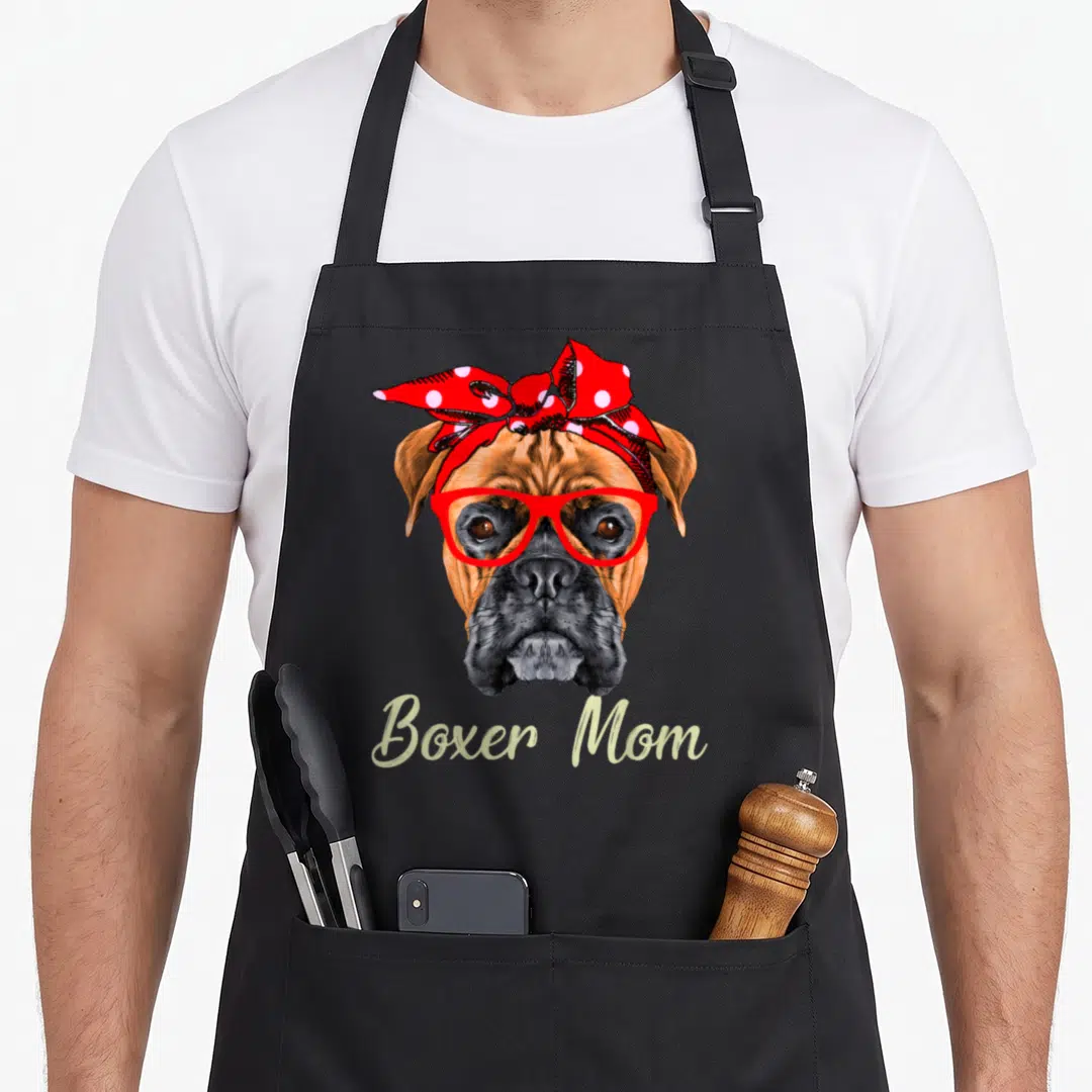 Mother boxer dog apron - Realistic boxer dog head with red glasses and red polka dot headband — shown on a black cotton canvas apron against a white background