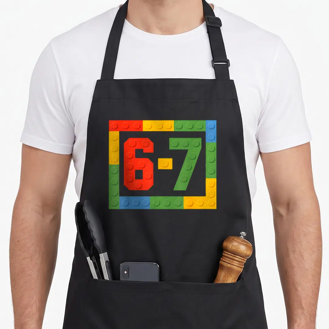 Six block & apron - 6-7 numbers made of red green yellow blue toy bricks in rectangular border — shown on a black cotton canvas apron against a white background