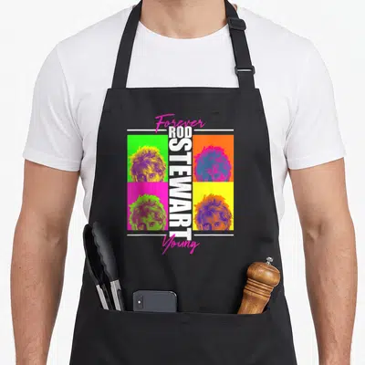 Forever rod apron - Four colorful portrait squares with vertical Rod Stewart text and pink script — shown on a black cotton canvas apron against a white background