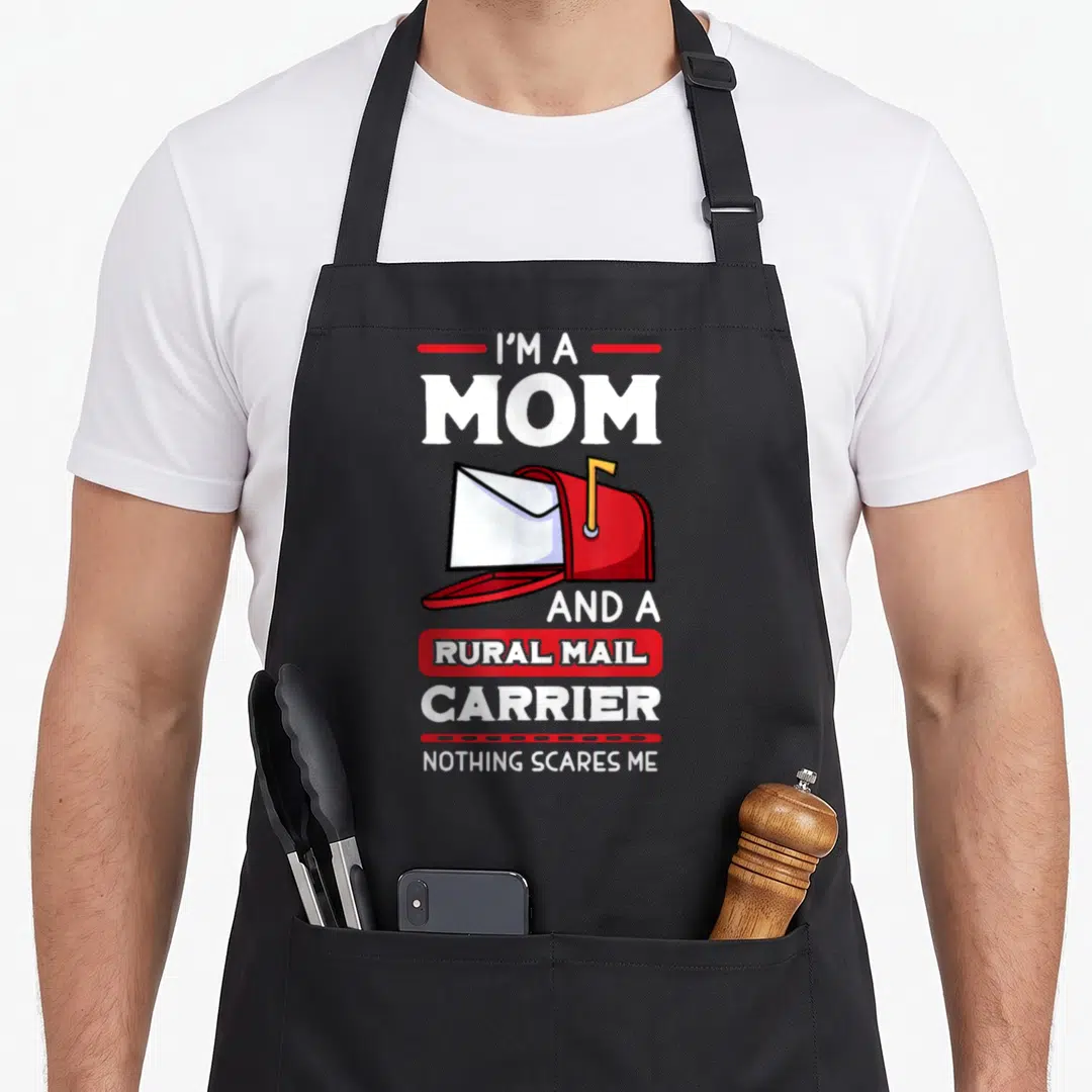 Carrier mother's day aprons - Red mailbox with white envelope between stacked white text reading I'm a mom and a rural — shown on a black cotton canvas apron against a white background