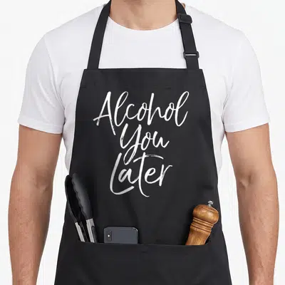 Alcohol beer apron - White script text Alcohol You Later stacked vertically on grey background — shown on a black cotton canvas apron against a white background