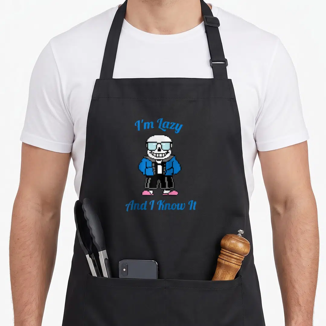 Pixel skeleton apron - Pixel skeleton in blue jacket and pink shoes between blue text lines — shown on a black cotton canvas apron against a white background