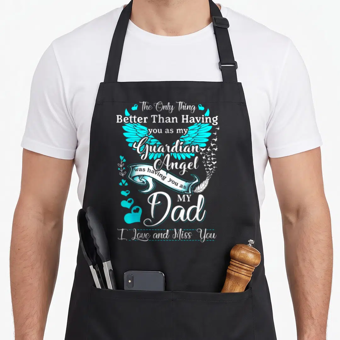 Missing angels and aprons - Cyan angel wings with white ribbon and text reading Better Than Having you as my Guardian — shown on a black cotton canvas apron against a white background