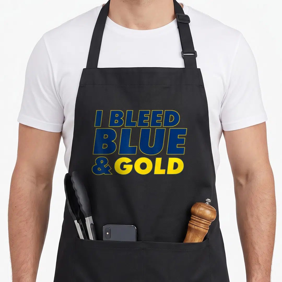 Bleed sport fan apron - Stacked text reading I BLEED BLUE & GOLD in blue and yellow letters — shown on a black cotton canvas apron against a white background
