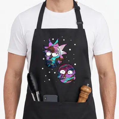 Funny space apron - Two character heads in purple blue pink cartoon style with white dots — shown on a black cotton canvas apron against a white background