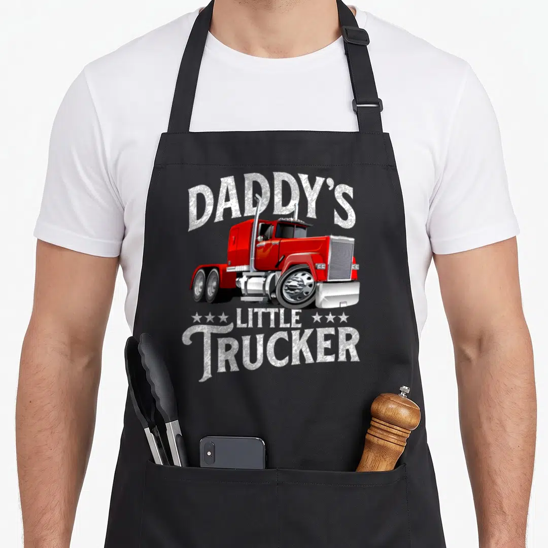 Daddy trucker semi truck apron - Red semi-truck with Daddy's Little Trucker text and stars — shown on a black cotton canvas apron against a white background
