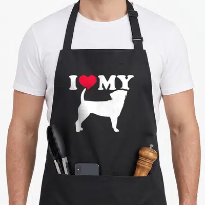 Retro puggle apron - White dog silhouette below I MY text and red heart — shown on a black cotton canvas apron against a white background