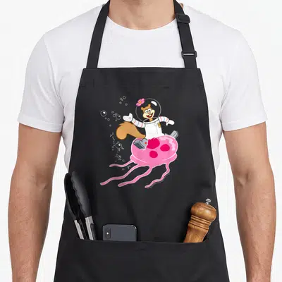 Squarepant jellyfish apron - Sandy Cheeks in spacesuit riding pink jellyfish with white bubbles — shown on a black cotton canvas apron against a white background