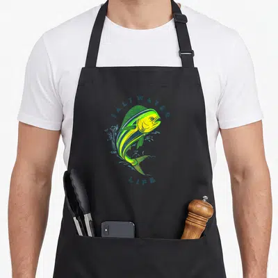 Saltwater fishing aprons - Jumping mahi mahi fish in yellow and blue with SALTWATER LIFE text — shown on a black cotton canvas apron against a white background
