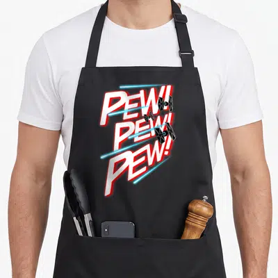 Fighter tie apron - Three stacked PEW! text lines with black TIE fighters and blue laser beams — shown on a black cotton canvas apron against a white background