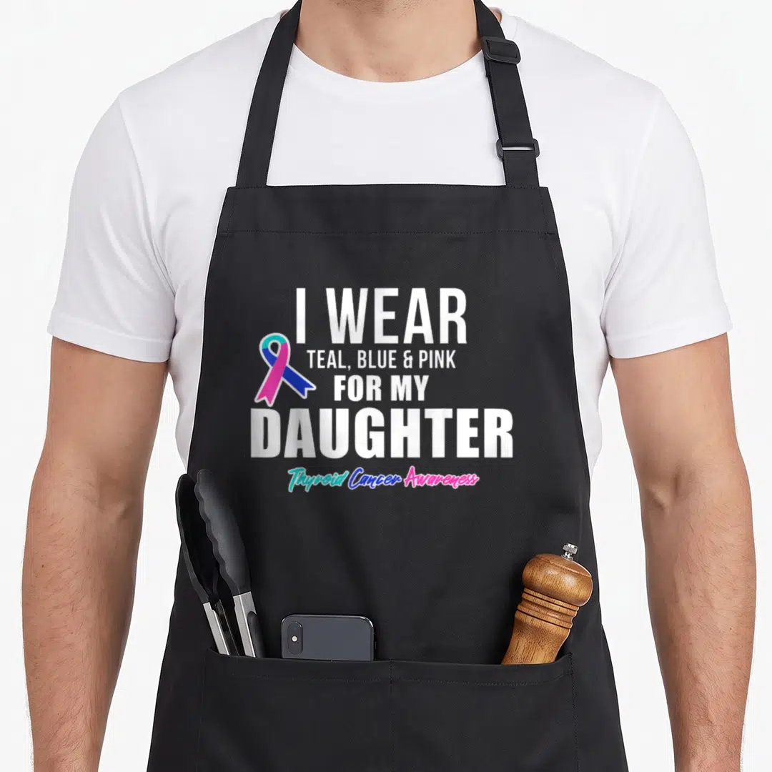 Daughter thyroid apron - I wear teal blue pink for my daughter thyroid cancer awareness ribbon text design — shown on a black cotton canvas apron against a white background