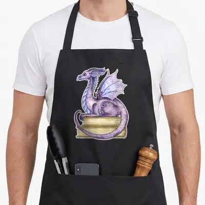 Amy the story of the apron - Purple watercolor dragon perched on stack of three tan books — shown on a black cotton canvas apron against a white background