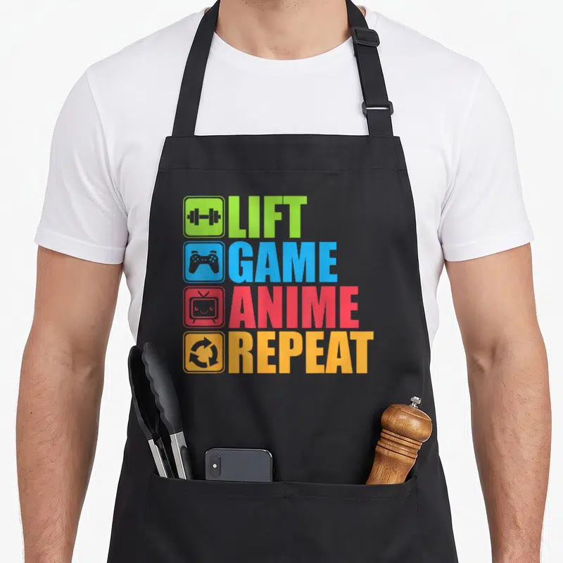 Lift geek aprons - Four colored rows reading Lift Game Anime Repeat with dumbbell, controller, TV, and recycle icons — shown on a black cotton canvas apron against a white background