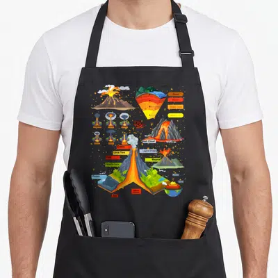Volcano chef outfit with apron - Cartoon volcano cross-section diagram with labels for crust, mantle, magma — shown on a black cotton canvas apron against a white background