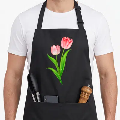 Beautiful tulip apron - Two pink tulips with green leaves and water droplets crossing at stems — shown on a black cotton canvas apron against a white background