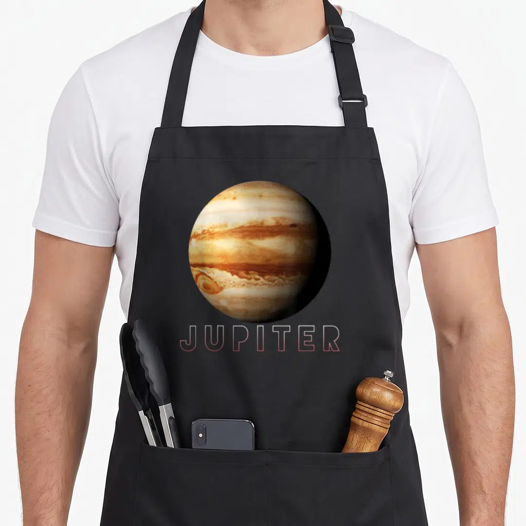 Jupiter planets galaxy men women kids apron - Realistic Jupiter planet with beige brown white pink bands and pink — shown on a black cotton canvas apron against a white background