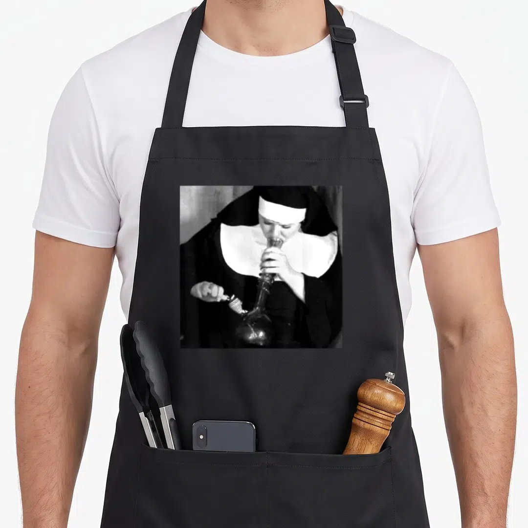 Nun smoking apron - Photo of a nun holding a glass bong and wooden honey dipper in black and white grayscale — shown on a black cotton canvas apron against a white background