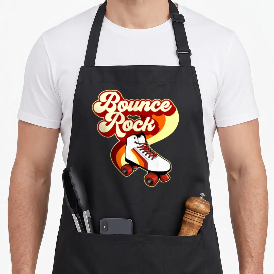Bounce 70s apron - Bounce Rock text above white roller skate on red orange yellow white retro wave — shown on a black cotton canvas apron against a white background