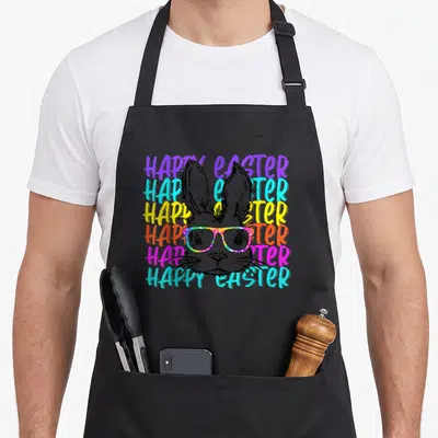 Glass rabbit easter bunny aprons - Rabbit head with rainbow glasses over six stacked HAPPY EASTER text lines in purple — shown on a black cotton canvas apron against a white background