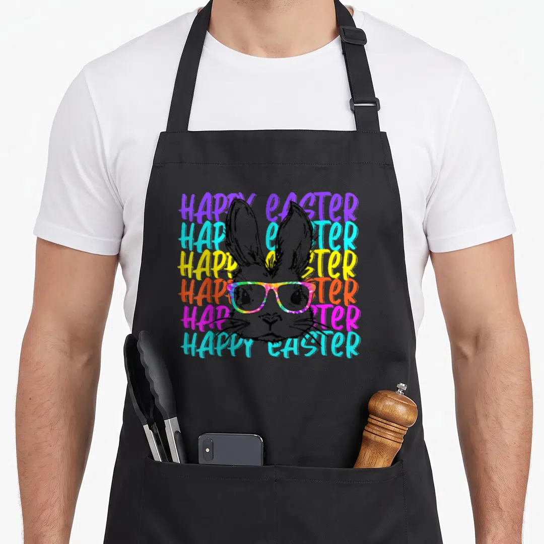 Glass rabbit easter bunny aprons - Rabbit head with rainbow glasses over six stacked HAPPY EASTER text lines in purple — shown on a black cotton canvas apron against a white background