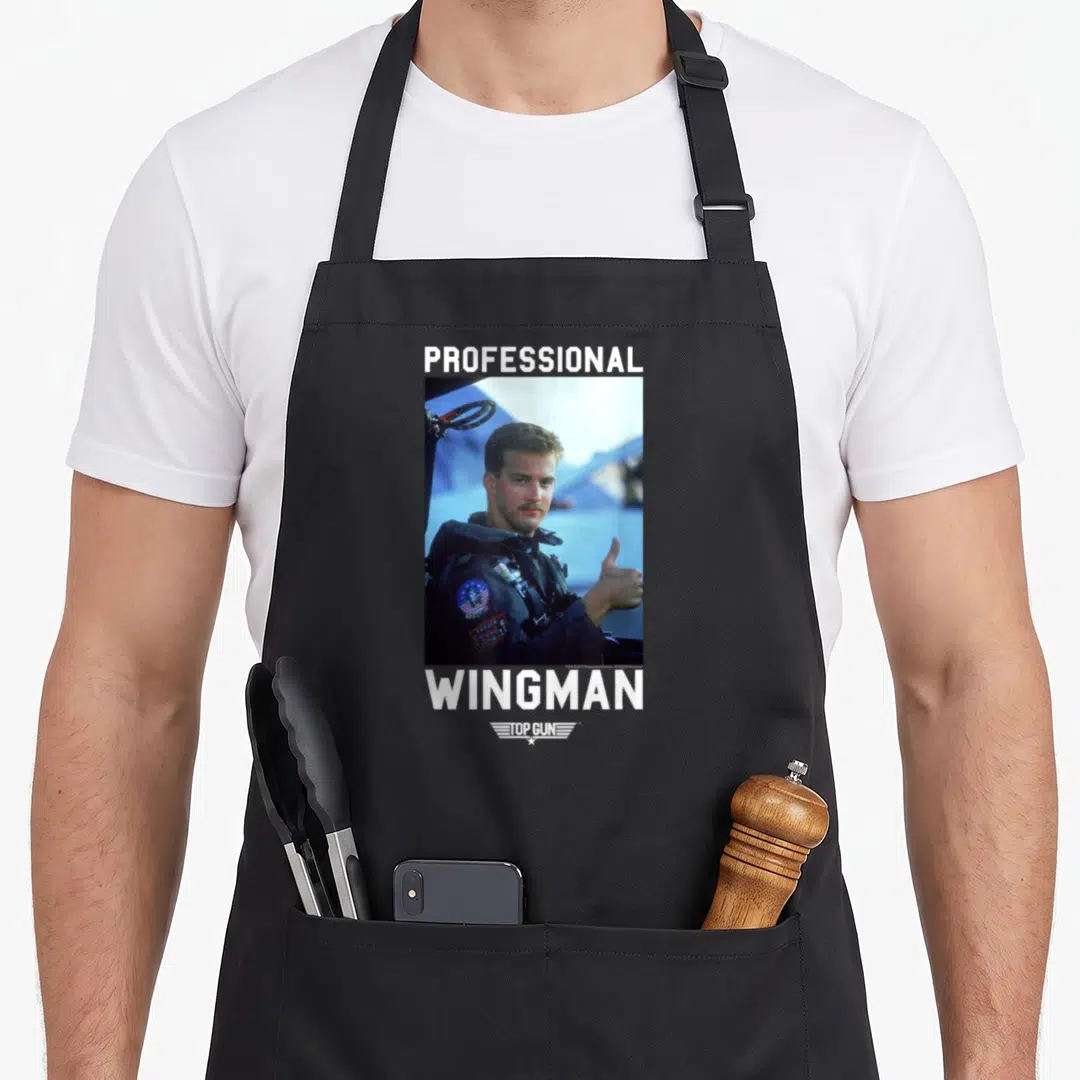 Gun professional apron - Pilot photo with PROFESSIONAL WINGMAN text and TOP GUN logo in grey white blue — shown on a black cotton canvas apron against a white background