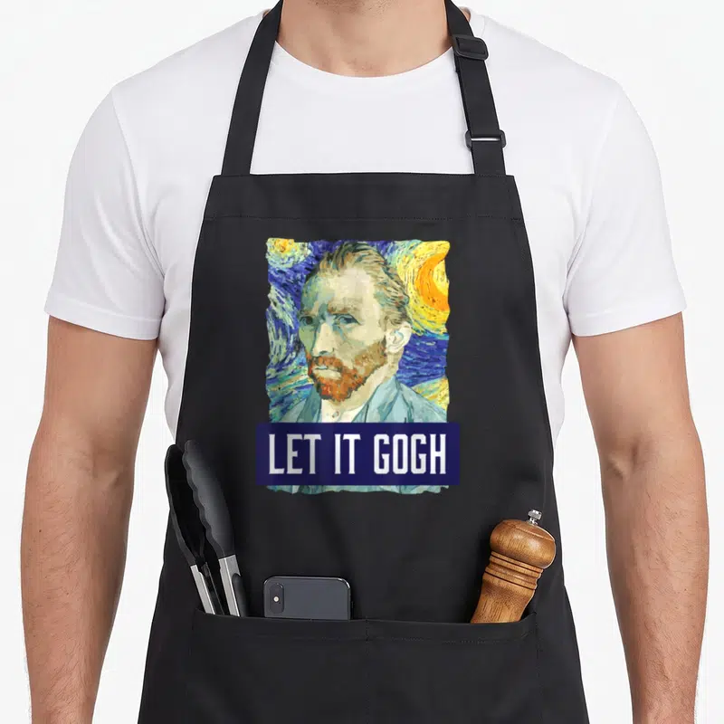 Artist van gogh apron - Cartoon Vincent van Gogh portrait with swirling sky and Let It Gogh text on blue banner — shown on a black cotton canvas apron against a white background