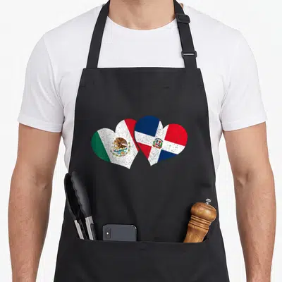 Dominican mexico apron - Two overlapping hearts filled with Mexican and Dominican Republic flags in green, white, red — shown on a black cotton canvas apron against a white background