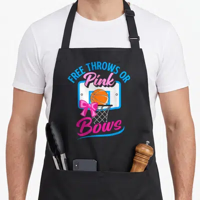 Free throw bow apron - Basketball hoop with pink bow and text Free Throws Or Pink Bows — shown on a black cotton canvas apron against a white background