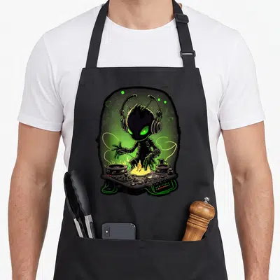 Alien djing apron - Cartoon alien with headphones behind DJ controller with fire and green oval aura — shown on a black cotton canvas apron against a white background