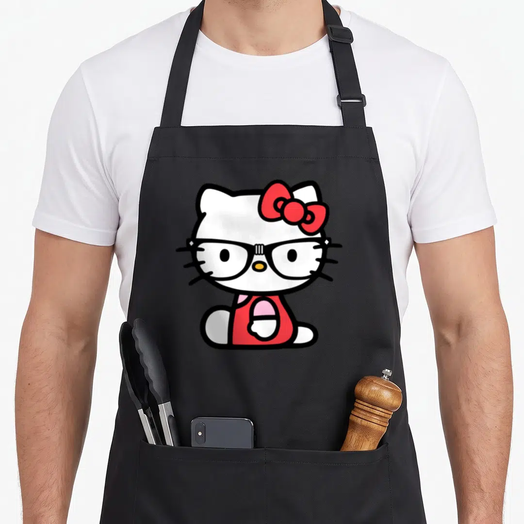 Retro glass nerd apron - Cartoon Hello Kitty wearing black glasses and red bow — shown on a black cotton canvas apron against a white background
