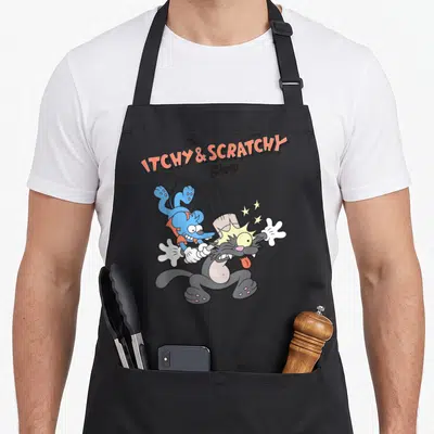 Itchy cartoon apron - Blue mouse hitting grey cat with mallet under arched Itchy and Scratchy Show text — shown on a black cotton canvas apron against a white background