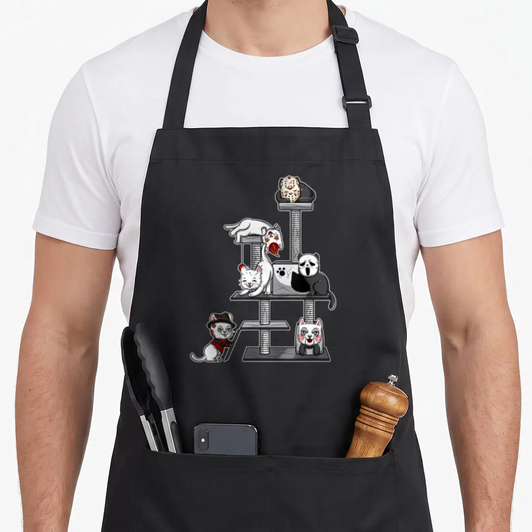 Horror cute cat apron - Five cartoon cats in horror costumes on a grey cat tree in white, grey, and black — shown on a black cotton canvas apron against a white background