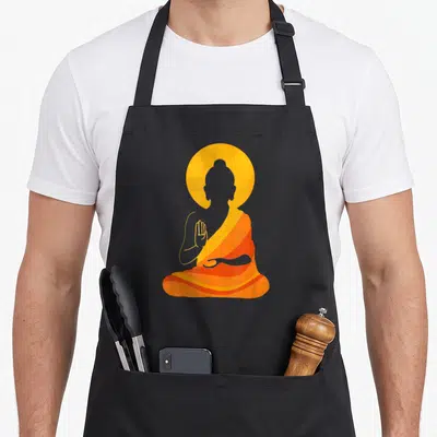 Buddha yin yoga apron - Minimalist Buddha silhouette in orange and yellow robes with circular halo behind head — shown on a black cotton canvas apron against a white background