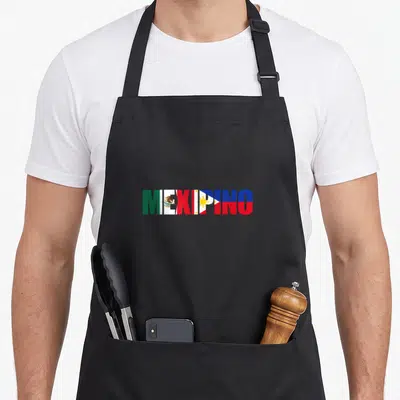 Mexipino mexican apron - MEXIPINO text filled with Mexican and Philippine flag stripes and symbols in green white red — shown on a black cotton canvas apron against a white background