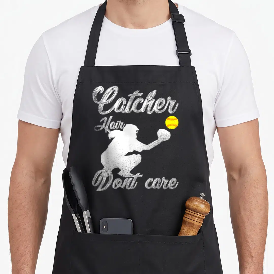 Player softball apron - Distressed catcher silhouette reaching for yellow ball with text Catcher Hair Dont care — shown on a black cotton canvas apron against a white background