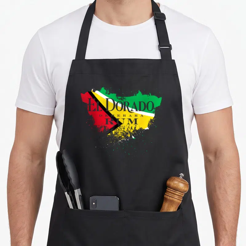 Dorado patriotic apron - Grey El Dorado Demerara Rum text over green yellow red Guyana flag paint splatter — shown on a black cotton canvas apron against a white background