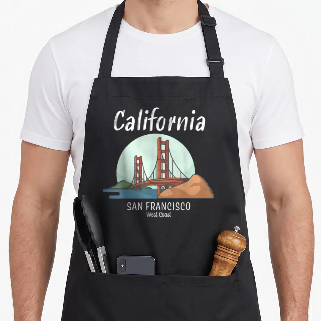 Golden san francisco apron - Minimalist Golden Gate Bridge in red-orange with California and San Francisco text — shown on a black cotton canvas apron against a white background
